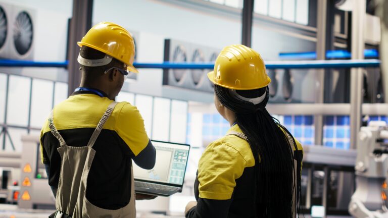 Engineering team working together to conduct routine inspections in industry 4.0 plant producing renewable energy. Photovoltaics smart factory teamworking colleagues testing equipment, camera B